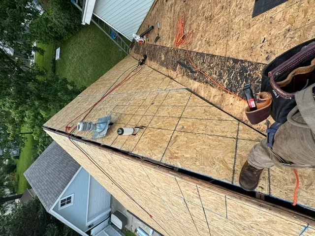 OSB roof decking installation with grid layout and fastening visible on residential roof frame
