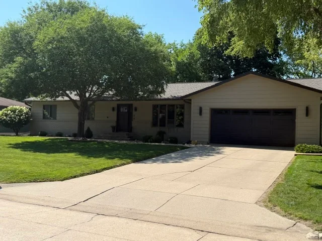 New gray asphalt shingle roof on single-story home with proper flashing and edge details