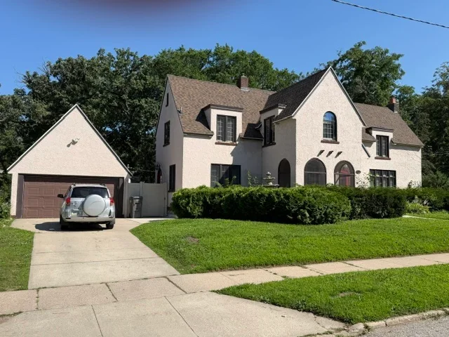 Two-story home with new asphalt shingle roof installation on multiple planes and dormers