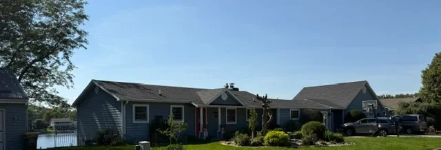 Dark gray asphalt shingle roof installation on residential home with multiple roof sections
