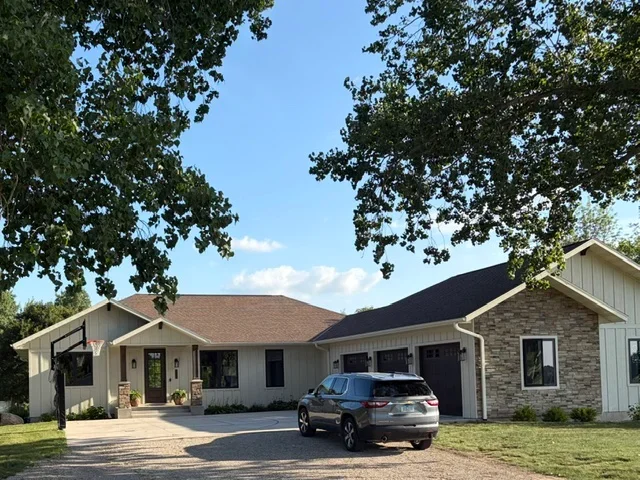 Dark architectural shingles installed on residential home roof with multiple planes and proper slope
