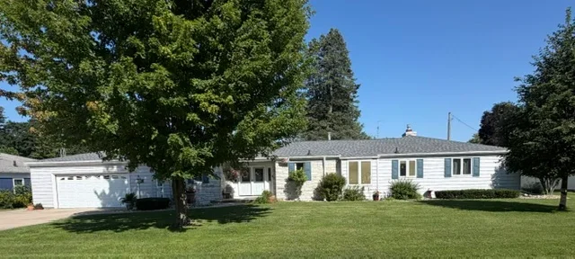 New asphalt shingle roof installed on single-story ranch home with attached garage