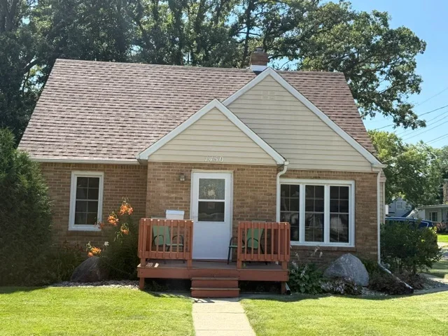 Brick home with new gray dimensional asphalt shingle roof and gable vents