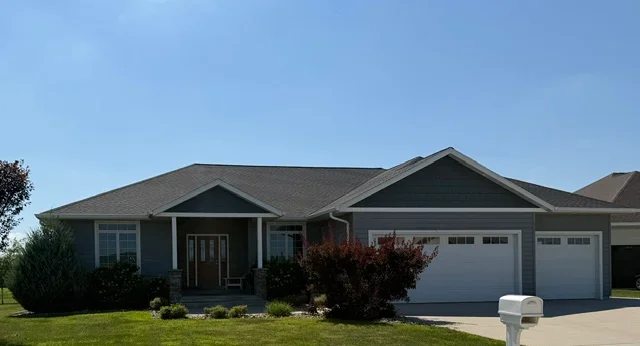 Charcoal gray asphalt shingle roof on single-story home with gable peaks