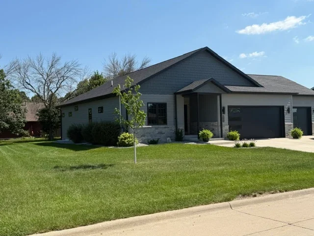 Dark gray architectural shingle roof on residential home with gable design and garage